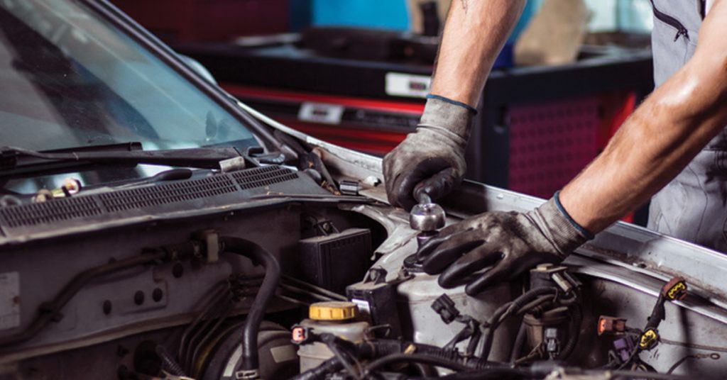 A human mechanic testing fitness of a car